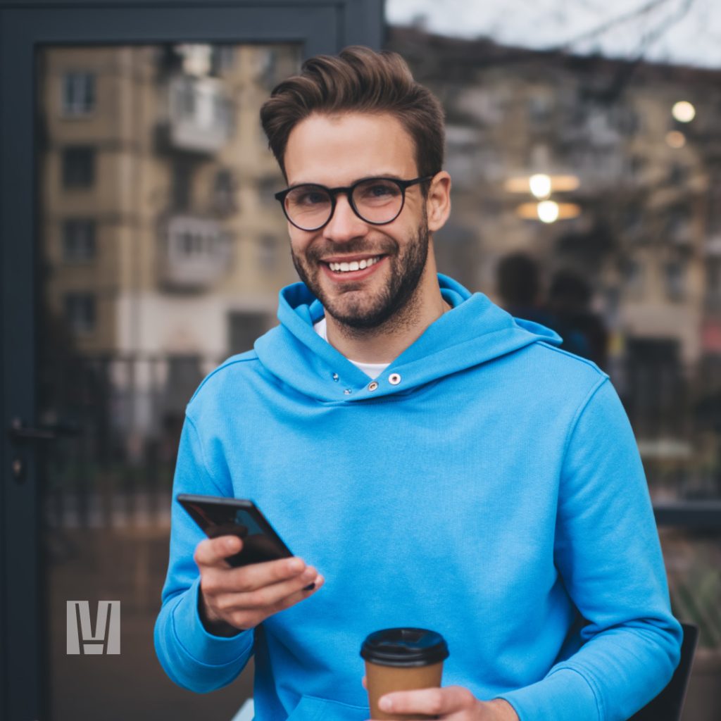 young man smiling view his phone
